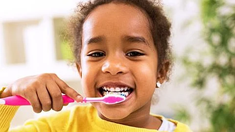 a girl brushing her teeth