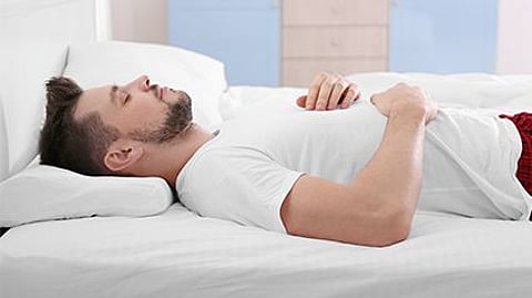 a man in a bed asleep