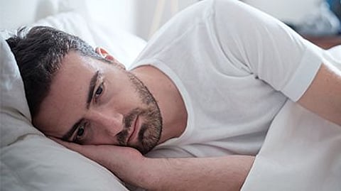 a man laying in a bed