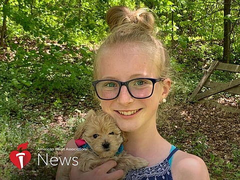 Heart disease survivor Abrielle Tallquist with her family’s new puppy