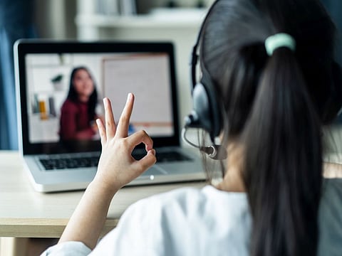 Young student at home on computer