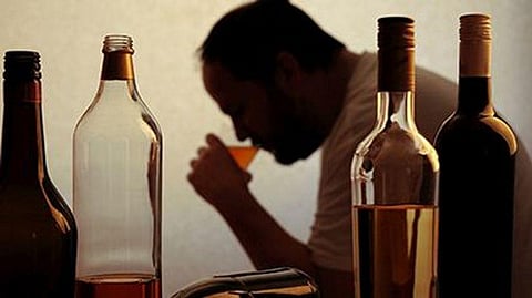 a man drinking alcohol