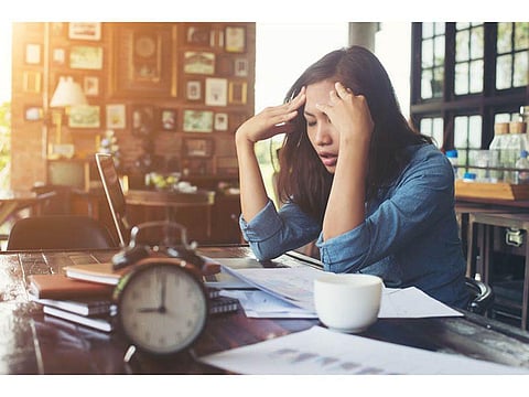 depressed woman behind desk