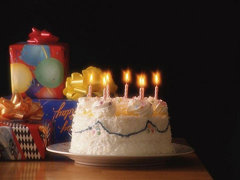 birthday cake with candles and presents