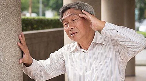 man holding his head in pain