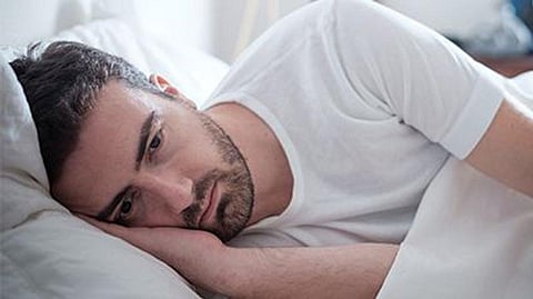 a man laying in a bed