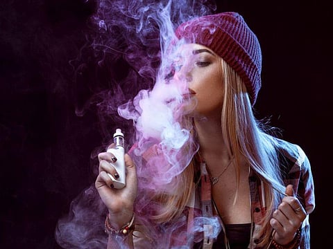 Women vaping e-cigarette