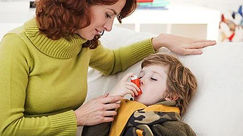 a mother giving a child an inhaler