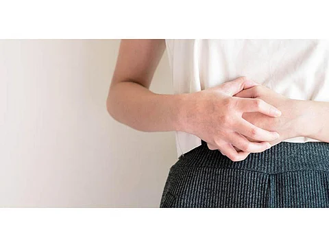 woman clutching stomach