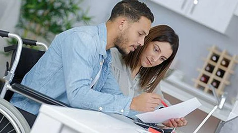 a couple reading paper at the table