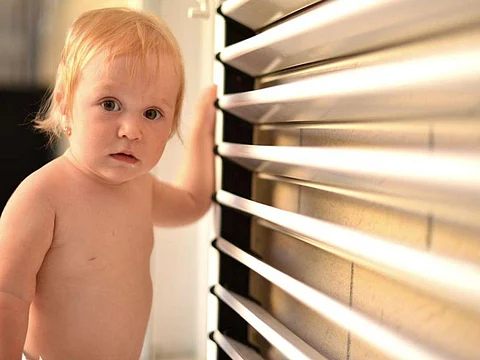 toddler near window blinds