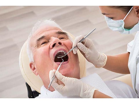 patient on the dentist chair during exam