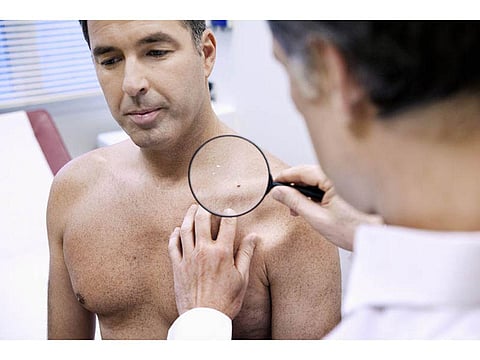 doctor examining patient's skin