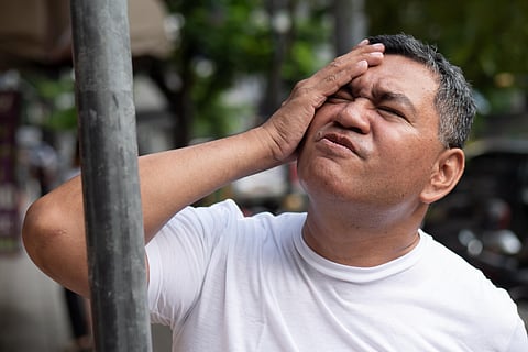 unlucky careless old senior man hitting his head with iron pole; concept of head injury, head accident, brain injury, brain lesion, memory loss, amnesia; asian senior man model