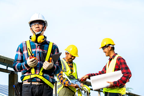 Engineer and technician discussion plan to find problem of solar panel