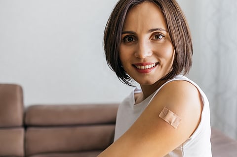 Portrait of smiling woman after getting a vaccine