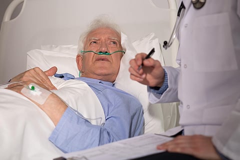 Elderly man examined by doctor