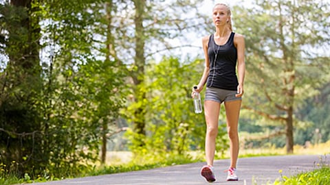 Woman walking in forest