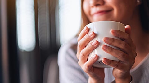 woman enjoying a cup of coffee