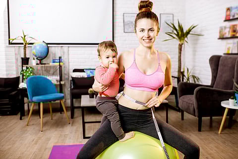 new mom exercising with her baby
