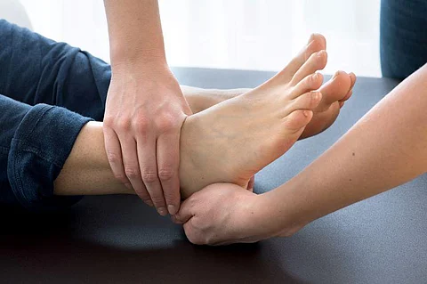 physical therapist working on ankle