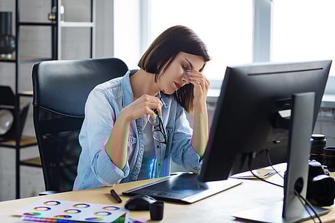 tired woman at desk