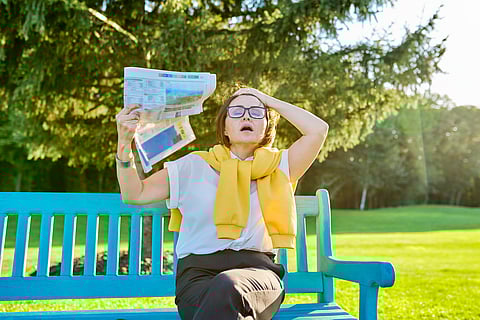 woman having hot flashes on bench