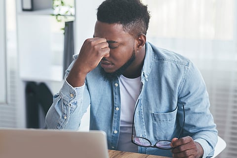 Black worker computer depressed fatigue eyes