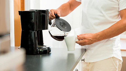 man pouring coffee