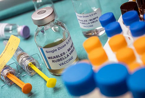 Different vials of triple viral vaccine of measles, rubella and mumps, known as MMR, conceptual image