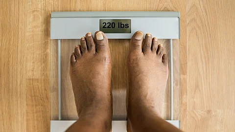 Obesity And Weightloss. Feet On Weight Scale. Pounds