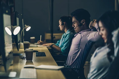 Asian Male customer care service with business woman working hard late in night shift at office,call center department,worker and overtime,team work with colleagues for success, 7 day 24 hour concept
