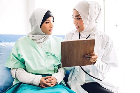 Muslim asian woman doctor service help support discussing and consulting talk to muslim woman patient at meeting health medical care express trust concept in hospital.healthcare and medicine