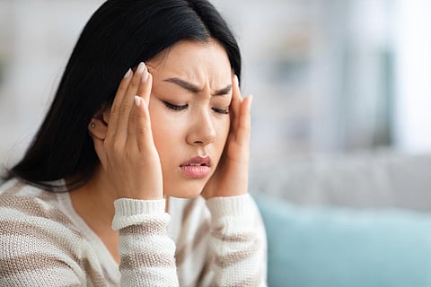 headache migraine asian woman