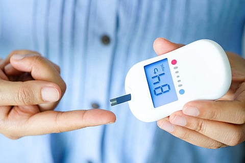 hand of people check diabetes and high blood glucose monitor with digital pressure gauge. Healthcare and Medical concept