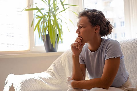 young woman thoughtful sad