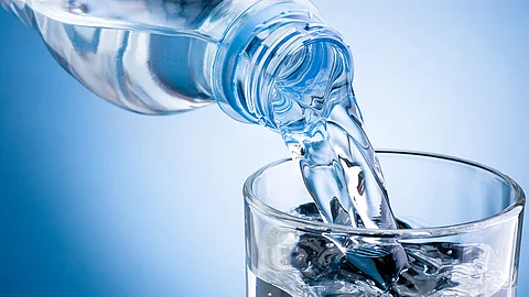 Pouring bottled water into a glass
