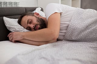 man sleeping in bed
