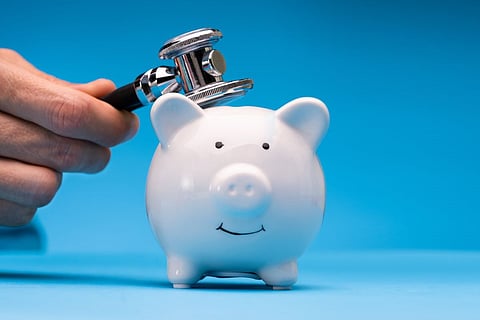 piggy bank health costs stethoscope