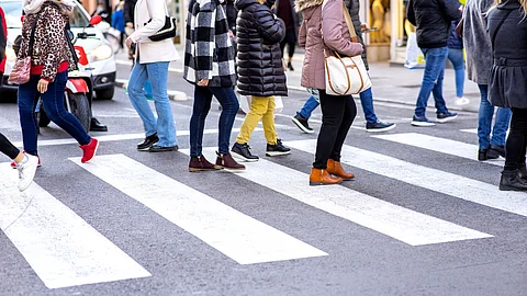 Peatones cruzando pasarela peatonal en la ciudad