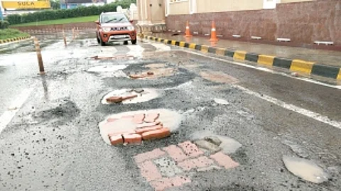 Main entrance road leading to Mopa Airport full of potholes