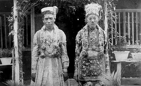 Old picture of a newly married Chitty couple. The groom A Subramaniam Pathair is wearing a traditional South Indian wedding dress and the bride L Chinamah Naiken is wearing the Baba-Nyonya headdress and the Malay Baju Kebaya Panjang Labuh. 
Images: K Nadarajan Raja