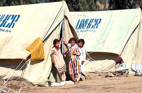 Refugees in Kashmir outside temporary housing provided by the UNHCR
Flickr/ United Nations Photo