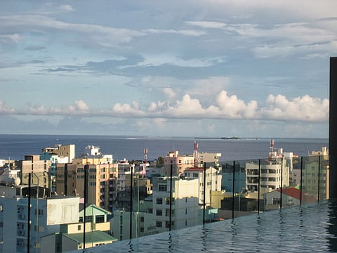 Maldives Male's skyline from an infinity pool. For many Maldivian youth, the ‘Emirati lifestyle’ beats a hard day’s work.    
Photo: Neil Merret