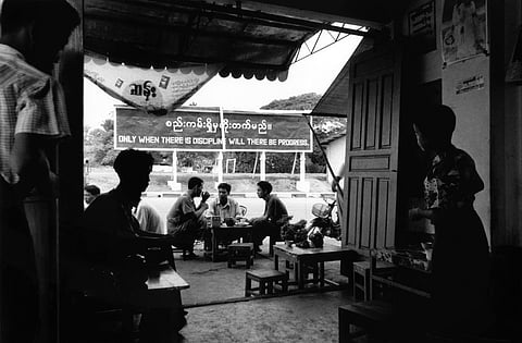 Pa An, Karen state 1998. Teashops are found all over Burma. Traditionally they are meeting places where many discussions and debates take place. The positioning of the signboard in this photograph may be accidental, but the 1988 uprising began after an incident at a teashop in Rangoon.