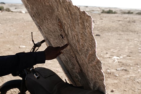 A man explains how umbrellas in a public park were made from poor materials and, therefore, broke just months after construction. All photos by Kevin Shi.