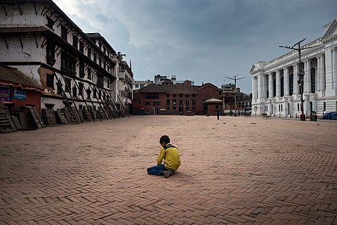 A child plays alone in an empty Kathmandu Durbar Square, a UNESCO World Heritage Site.