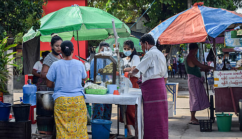 A snack vendor in Yangon’s Insein Township draws customers who are not too keen on physical distancing and face mask etiquette.  Photo: courtesy of Kyaw Lin Htoon.