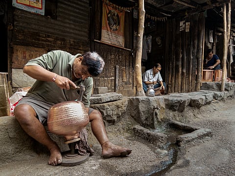 Three artisans working on copper vessels at their workshops in Tambat Ali. Photo courtesy: Sagar Shiriskar.