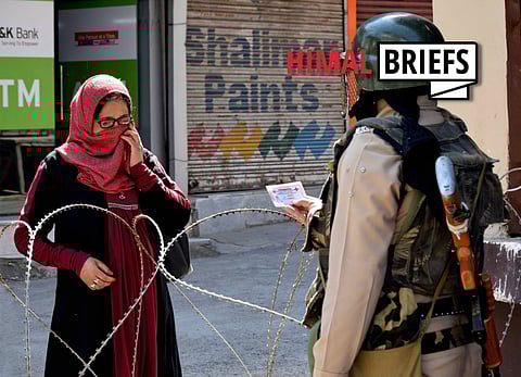 A paramilitary officer checks identity-cards amid curfew restrictions imposed in in Srinagar, Kashmir by authorities to control protests against Shopian district civilian killings. July 2017. Photo: Pacific Press Agency / IMAGO
